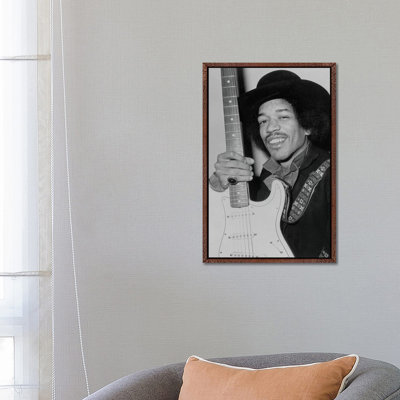 A Smiling Jimi Hendrix Holding His Guitar by Radio Days - Print on Canvas