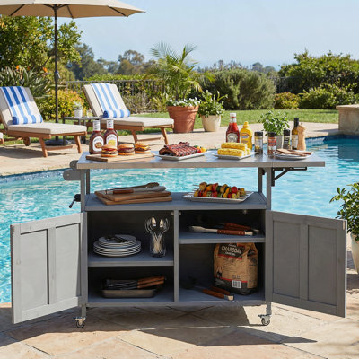 Îlot de cuisine extérieur pliable avec roulettes verrouillables, armoire de rangement et porte-serviettes pour une cuisson efficace sur la terrasse