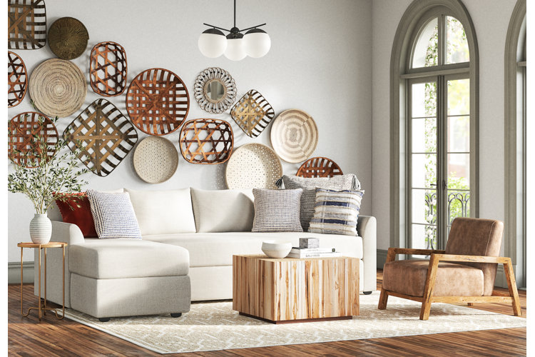 organic modern living room with a warm neutral color palette, ivory sofa, and woven wall accents