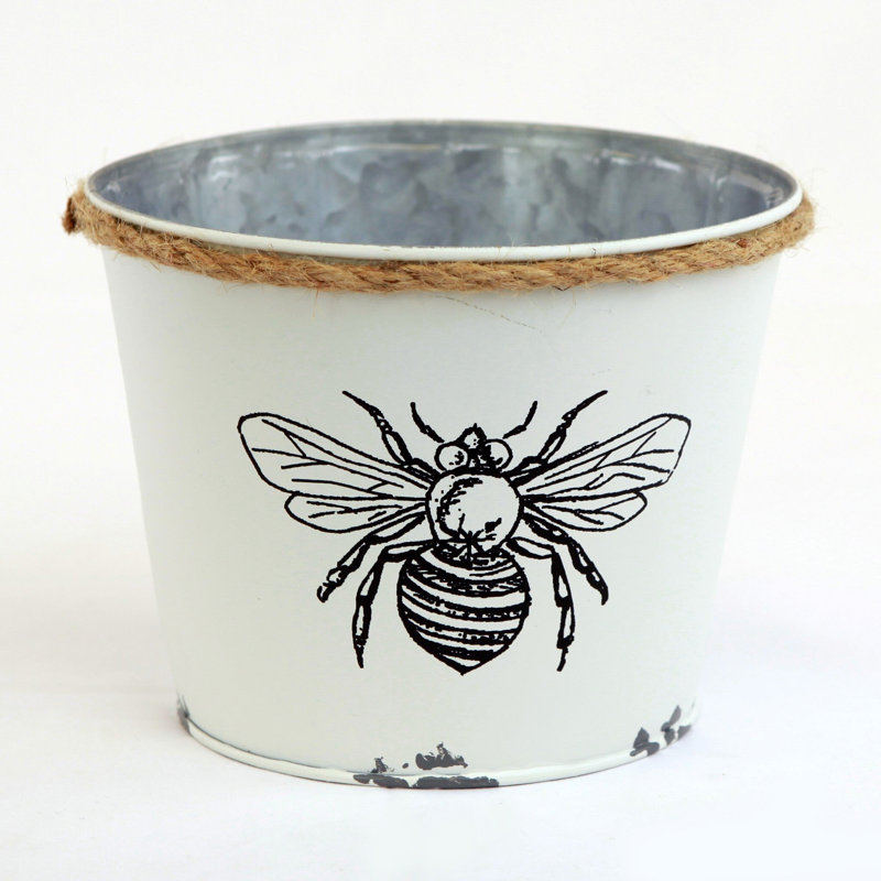 Pot à fleurs blanc avec abeille noire