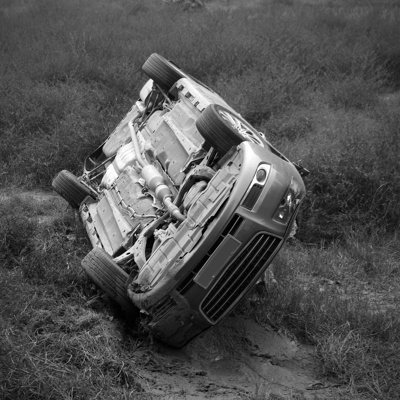 A Black And White Picture Of A Car Overturned by Zhangguifu - Print