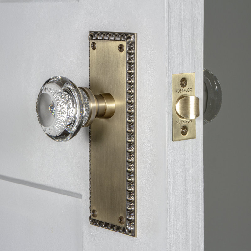 Nostalgic Warehouse Neoclassical Plate Passage (Hall & Closet) with Crystal Neoclassical Knob, Antique Brass, 2.75"