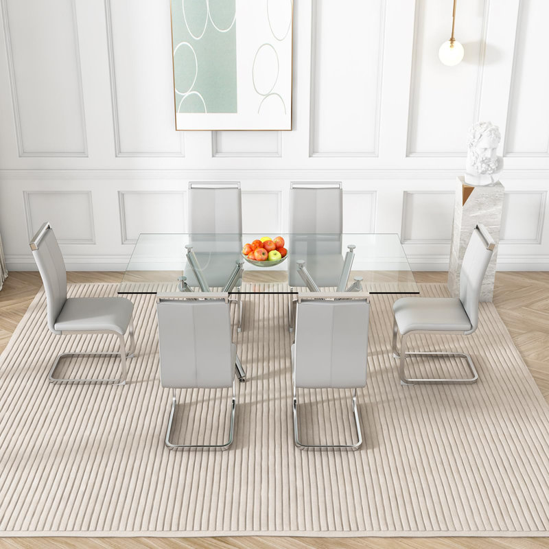 Ensemble de table de salle à manger moderne Daarina, grande table rectangulaire en verre avec base en X argentée et chaises en porte-à-faux en similicuir