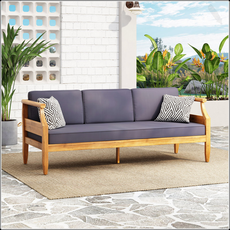 Canapé d'extérieur ASTON 3 SEATER avec accoudoirs encastrés et structure en bois d'acacia durable, parfait pour une détente élégante et confortable.