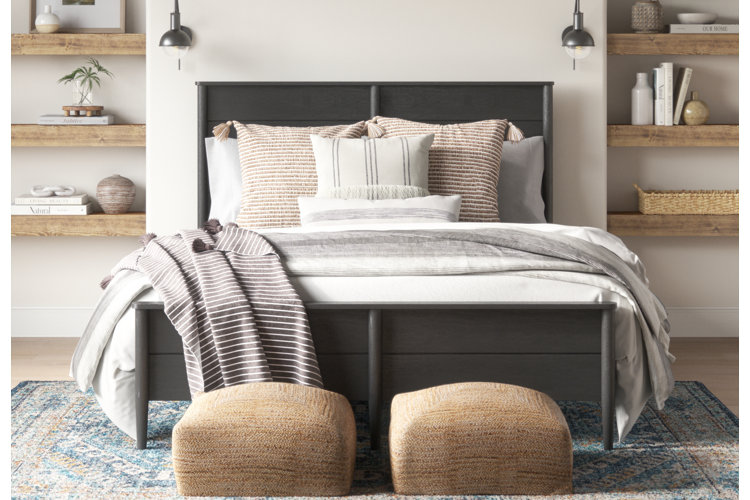 coastal bedroom with layered bedding and throw blankets