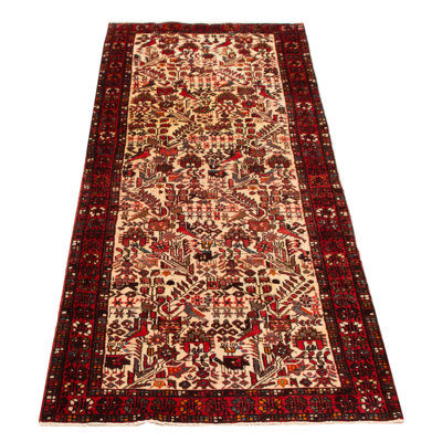Splendid piece of work that is woven in Turkey with a re-interpretation of village Persian designs. The vintage and distressed look make this hand-knotted wool rug a natural standout.