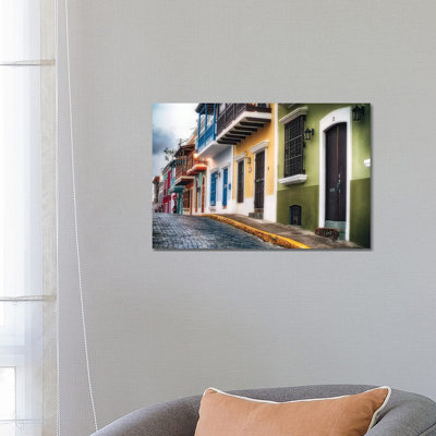 Low Angle View Of Houses On A Cobblestone Street by George Oze - Wrapped Canvas Painting