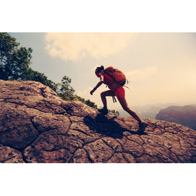 Hiker Climbing Rock by Lzf - Wrapped Canvas Print