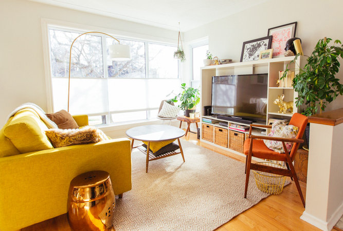 A living room with a yellow sofa