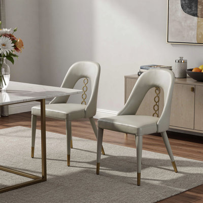 Ensemble de deux chaises d'appoint en similicuir gris et or et acier inoxydable
