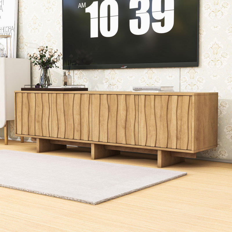 Meuble télé avec portes d'armoire ondulées, système de gestion des câbles, accès par pression et dispositif anti-basculement