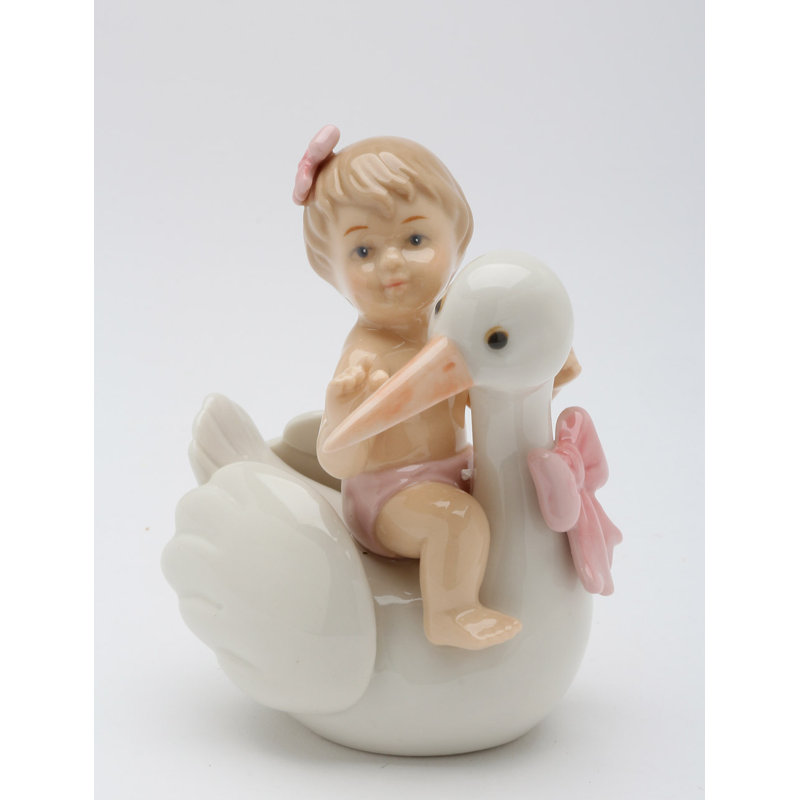 Figurine petite fille sur une cigogne 
