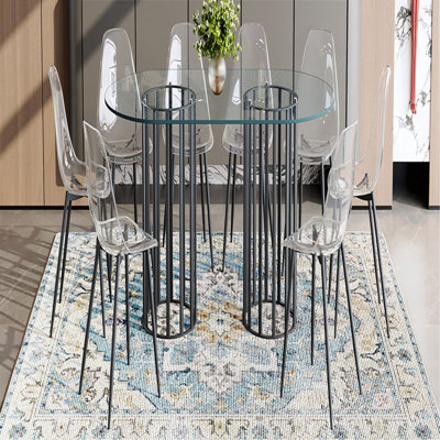 Ensemble de table et de chaises Table de salle à manger ovale en verre trempé de 71 pouces de style luxueux à double colonne noire. Jumelé avec 8 chaises en plastique transparent avec pieds en métal noir.