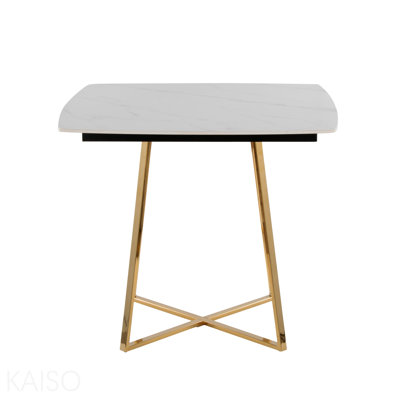 Table avec base en métal doré et bois noir avec plateau en céramique effet marbre blanc