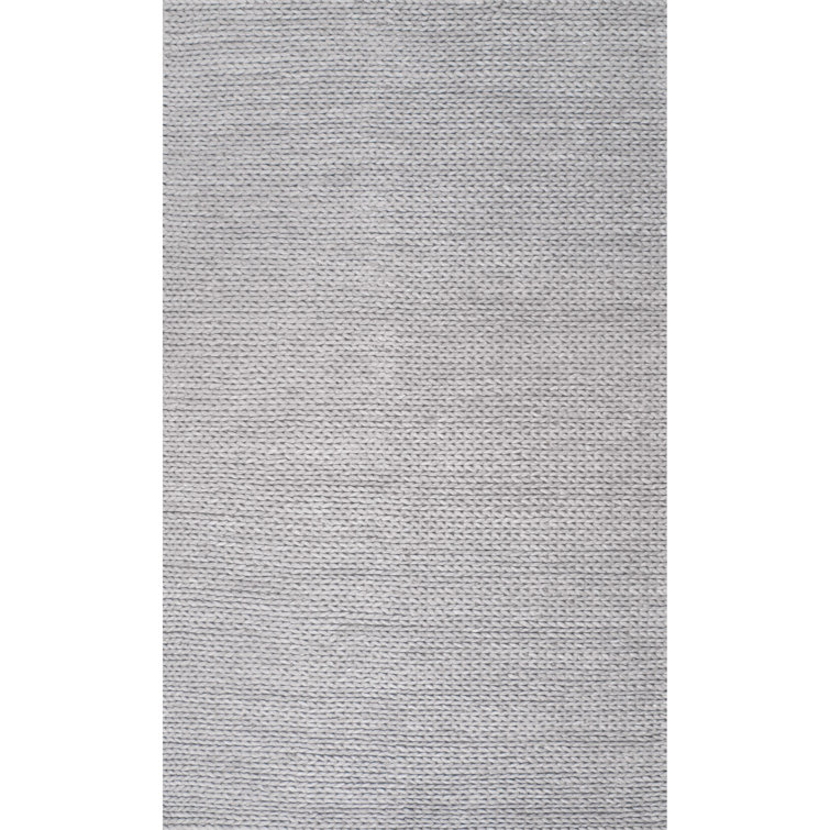 Tapis gris clair en laine tressé à la main