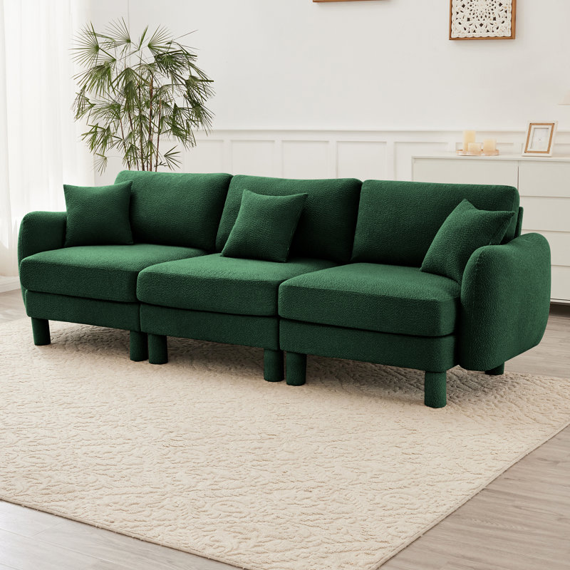 Canapé à trois places en tissu Boucle avec accoudoirs en forme de coquille distinctive et pieds cylindriques enveloppés de tissu, idéal pour divers espaces de vie