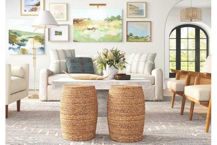Living room with gallery wall of paintings and two wicker coffee tables