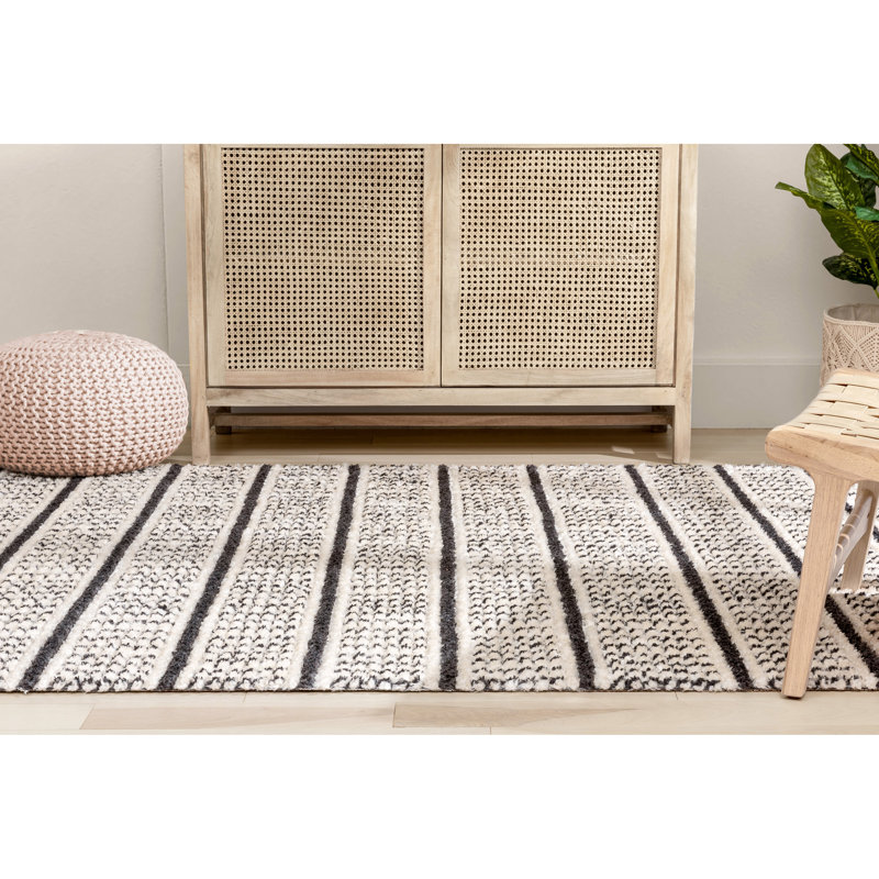 Ivory and Black Geometric Synthetic 4' x 6' Area Rug