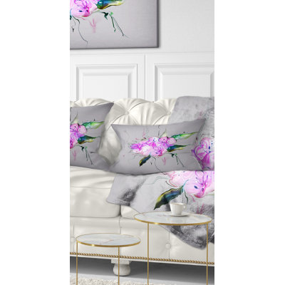 Coussin décoratif imprimé de fleurs mauves et roses