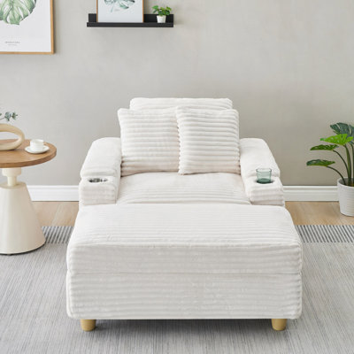 Canapé simple en velours côtelé avec un coussin, deux coussins, un repose-pieds et deux espaces de rangement.