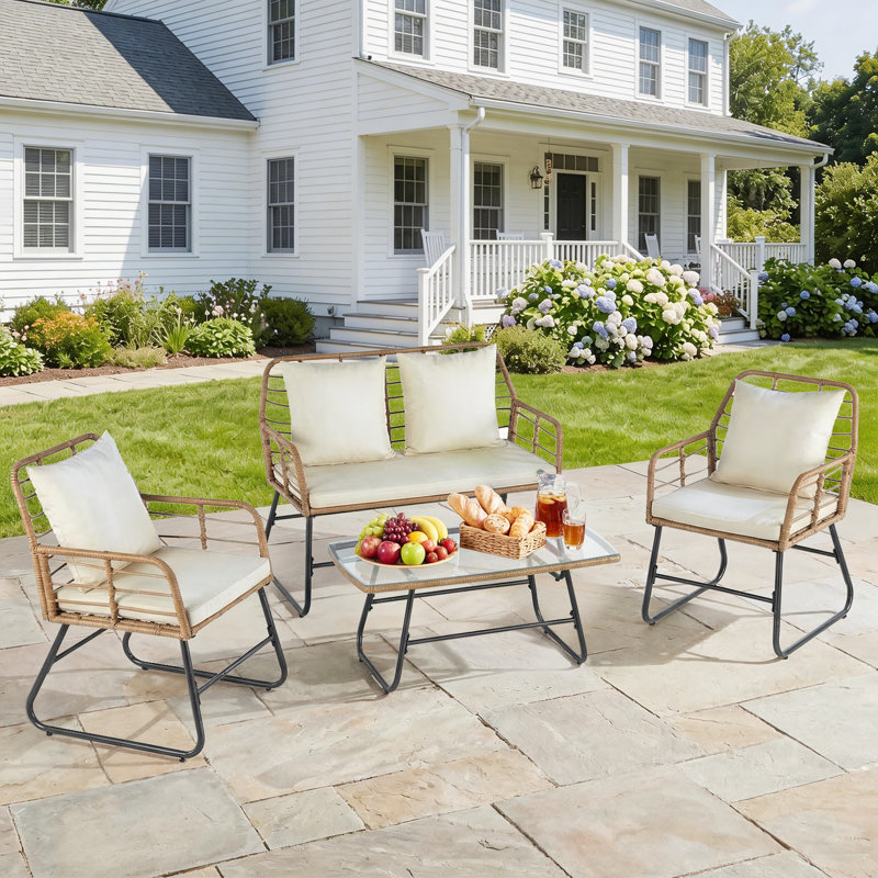 Ensemble de mobilier d'extérieur 4 pièces Chanera, ensemble de patio en osier avec coussins épais en structure sandwich, canapé en rotin toutes saisons à assise profonde et table fonctionnelle en verre pour porche et pelouse