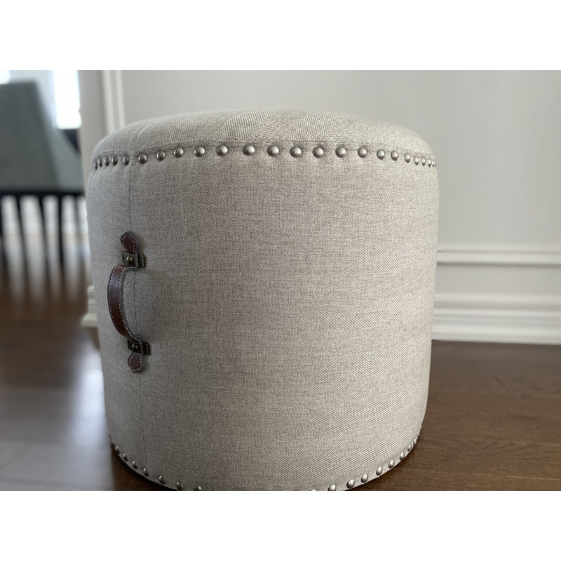 Johnny Fabric Upholstered Round Pouf Ottoman with Faux Leather Handle, Beige Polyester