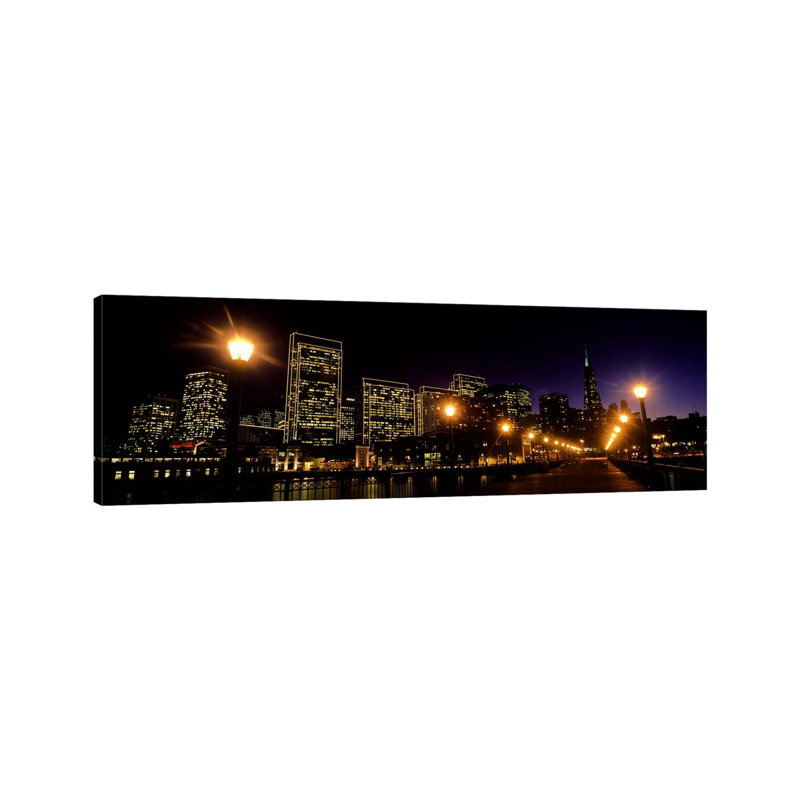Buildings At The Waterfront Lit Up At Night, San Francisco, California, USA by Panoramic Images - Wrapped Canvas Panoramic Print