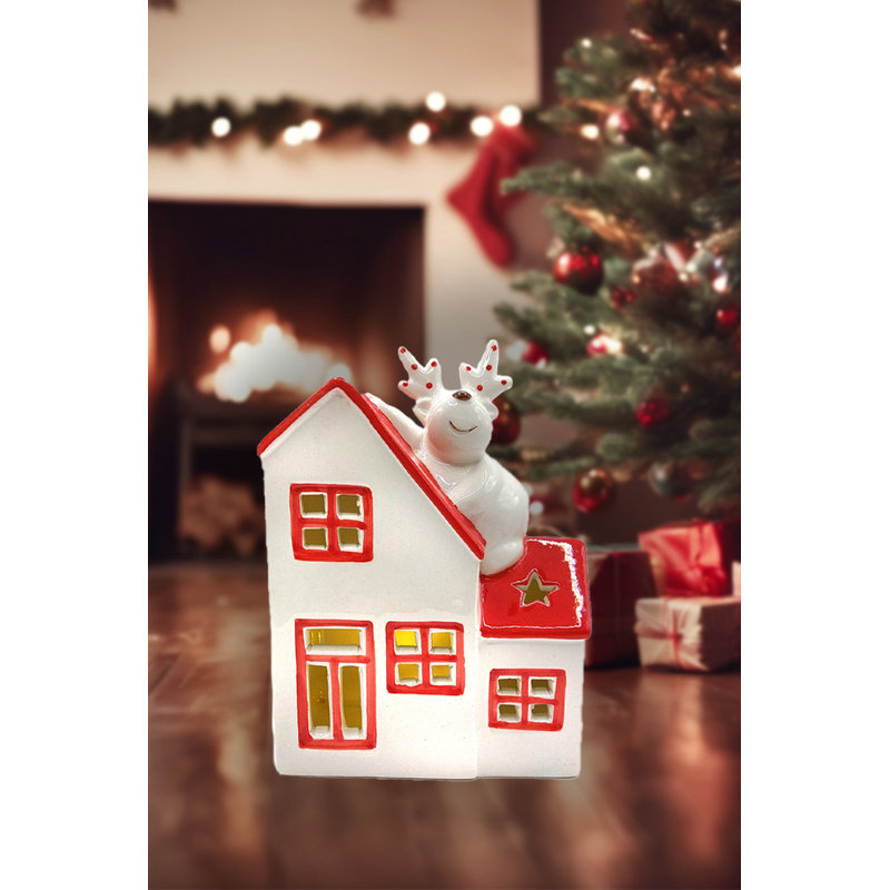 Ornement de Noël en céramique - chalet de Noël avec renne par Wizardi
