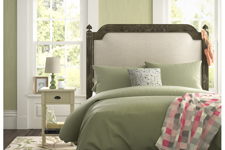 sage green bedroom with upholstered headboard