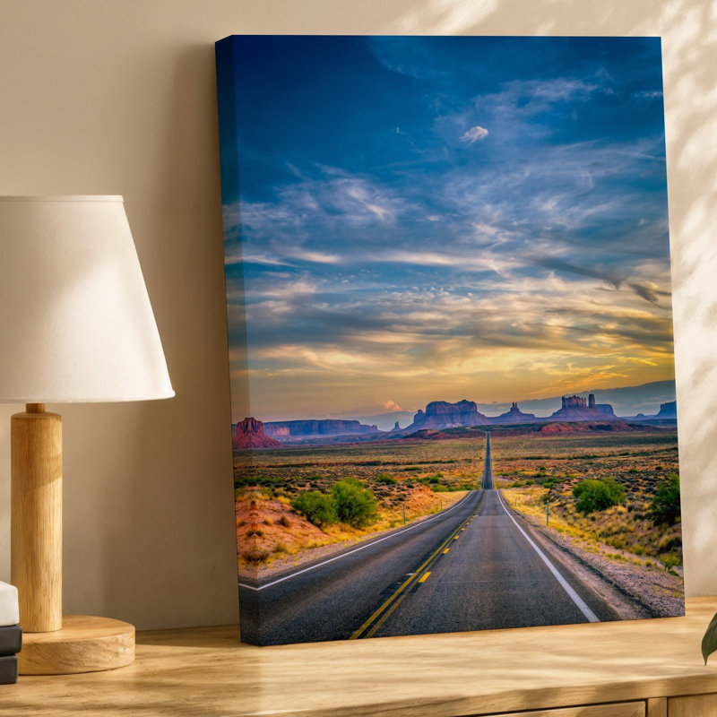 Toile «A Long Winding Asphalt Road Stretches Through A Vast Desert», art mural, paysage encadré de roches rouges