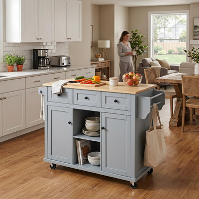 Îlot de préparation mobile gris et bleu pour la salle à manger, surface de travail pliante en bois d'hévéa, supports de rangement pour porte intégrée, 1 armoire fermée et 3 tiroirs, 5 roulettes à roulement en douceur