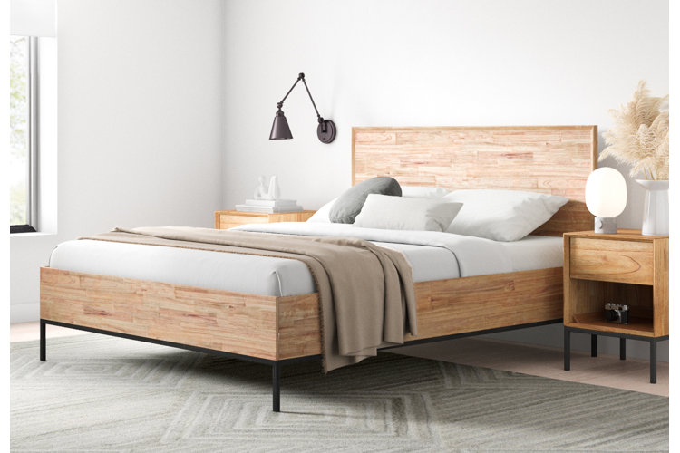 Minimalist bedroom with wood-framed bed and matching wood nightstands.