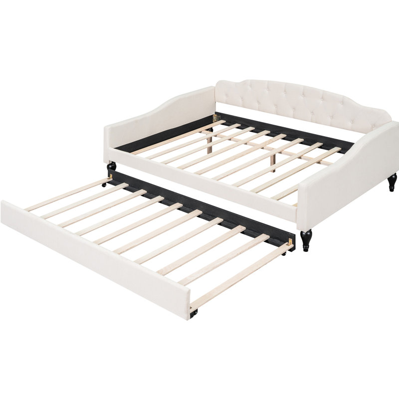 A Full-Size Upholstered Daybed With Tufted Design And A Built-In Twin-Size Trundle Bed