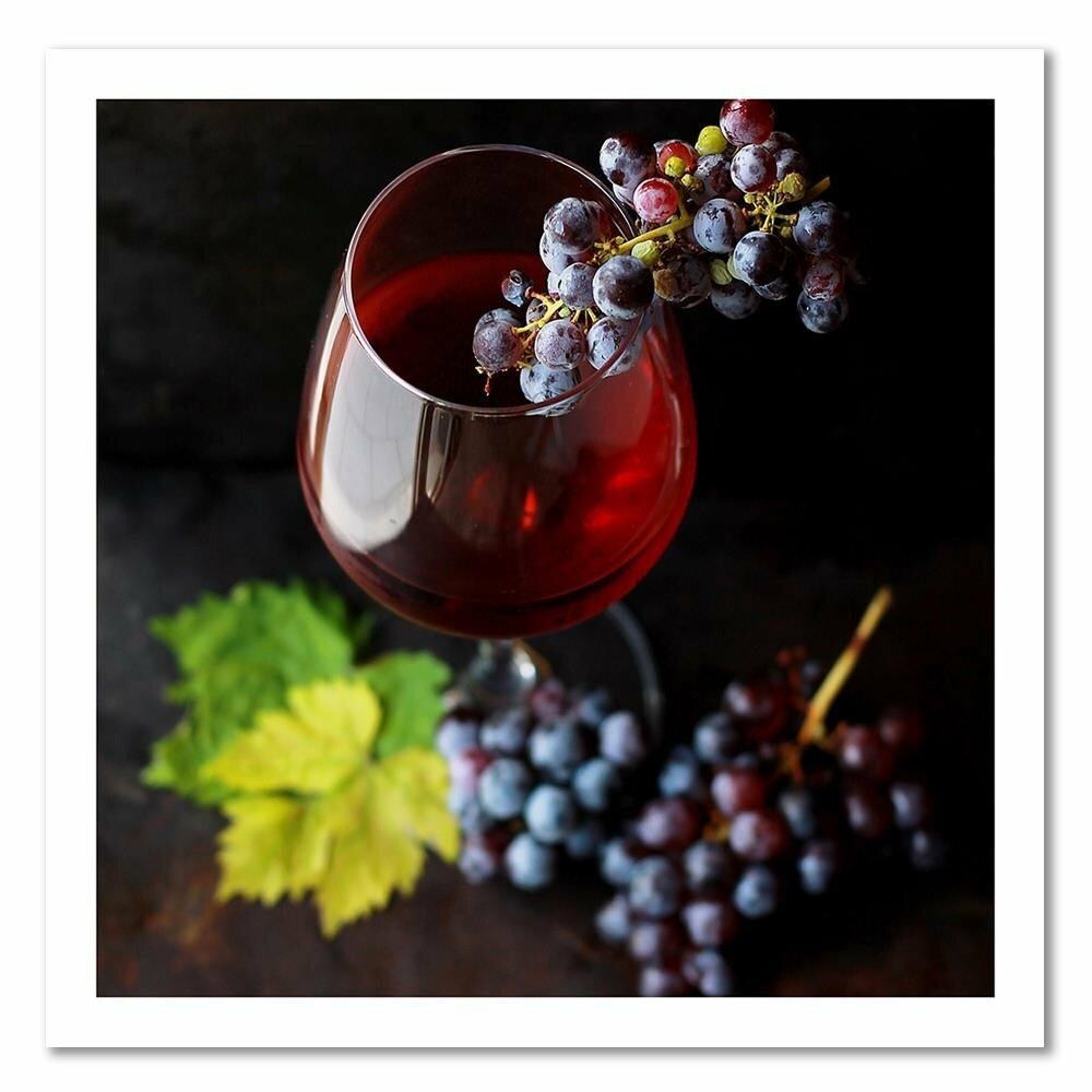 Leinwandbild Ein Glas Wein und Trauben