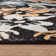 Tapis noir à motif floral multicolore