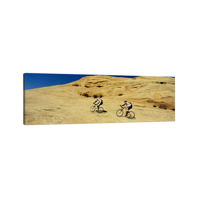 Side Profile Of Two Men Mountain Bilking On Rocks, Slickrock Trail, Moab, Utah, USA by Panoramic Images - Wrapped Canvas Panoramic Print