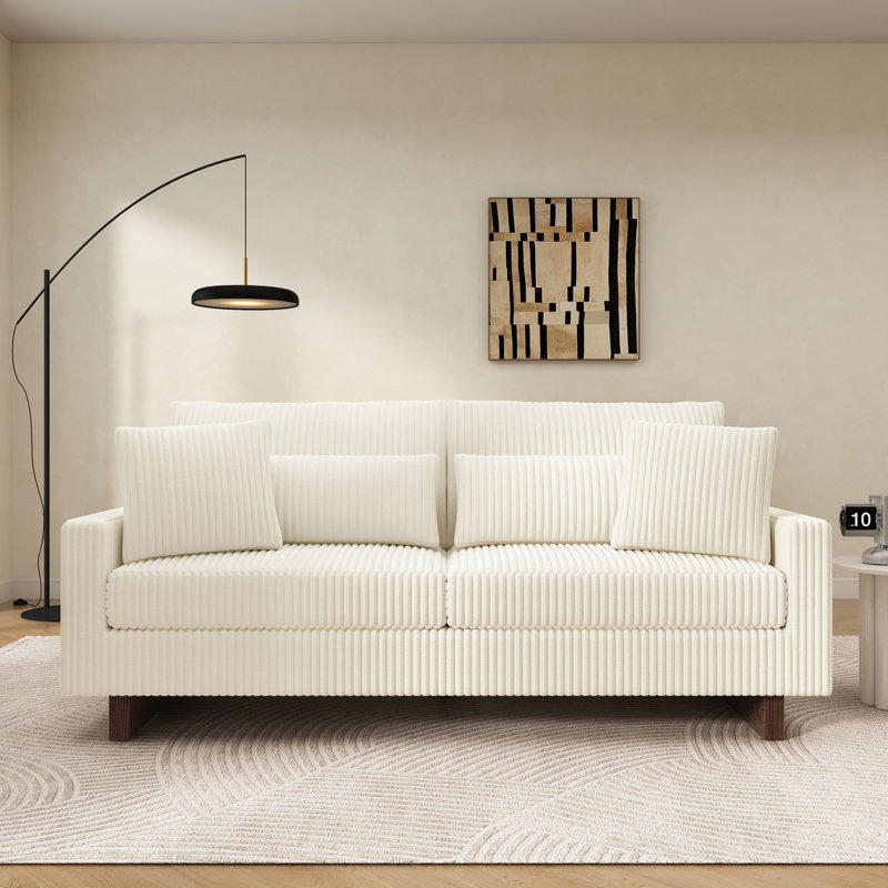 Canapé moderne en velours côtelé avec quatre coussins, mousse haute densité et support à ressorts pour un salon confortable.