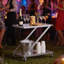 Modern Bar Cart with Tempered Glass Shelves, Z-Frame Design, and Lockable Rolling Casters for Stylish Functionality.