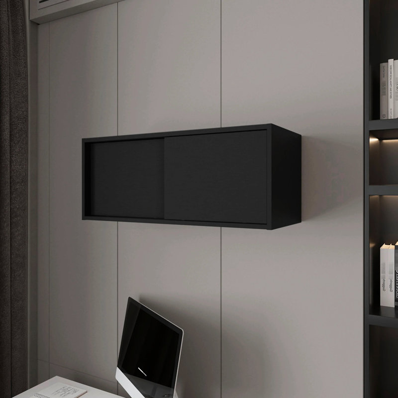 Élégante armoire flottante noire avec porte coulissante facilitant l'utilisation de l'espace de vie