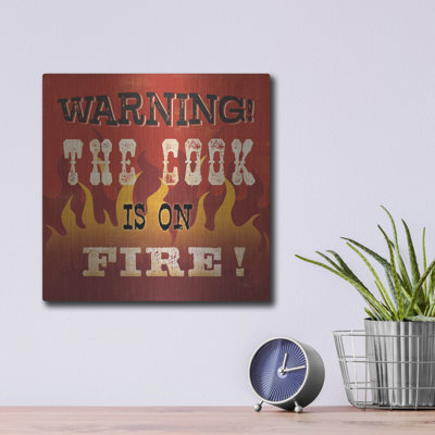 «The Cook Is On Fire» par Pela Studio, art mural en métal