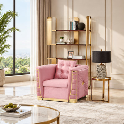 Fauteuil simple en velours de luxe avec coussin décoratif et détails en métal doré