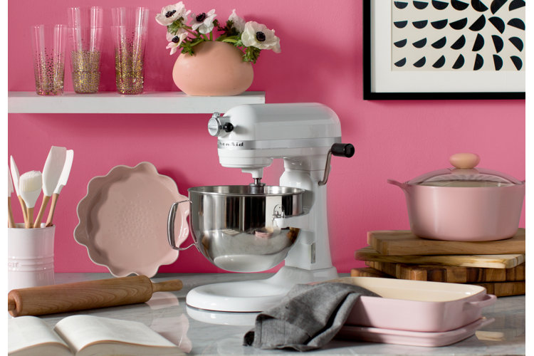 pink cookware with white mixer and shelves