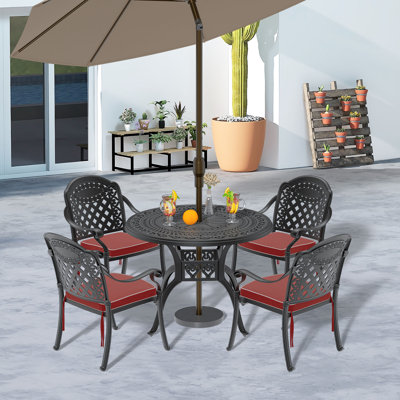 Reontae 4 - Person Patio Dining Set with Round Table , Cushions Included