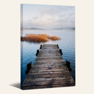 Wooden Dock Extending Into Misty Lake With Golden Reeds Canvas Wall Art