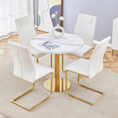 Ensemble de table et de chaises Table de salle à manger ronde élégante de 31,5 pouces à motif de marbre blanc - texture annulaire moulée par aspiration. Combinée avec 4 chaises en polyuréthane de haute qualité avec des pieds arqués en métal doré