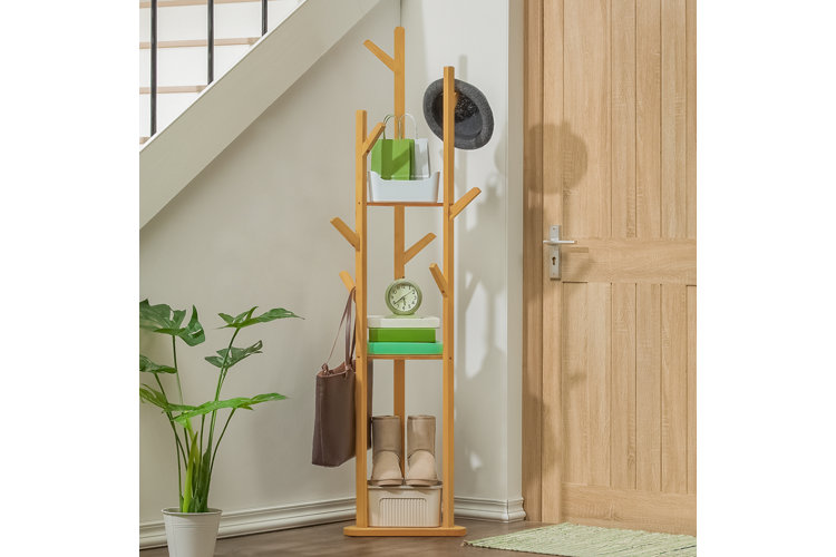 brown wood standing coat rack with hats hanging from it