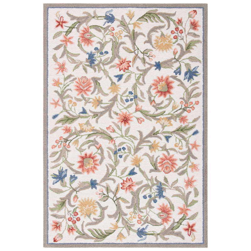 Ivory area rug with a multicolored floral pattern and hooked wool texture.