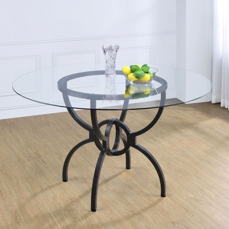 Table ronde de 122 cm (48 pouces) avec finition canon de fusil, plateau en verre trempé de 6 mm et piètement sculptural en métal, style rustique, avec plateau en verre transparent et pied central.