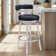 Deherrera Modern Swivel Counter or Bar Stool with Open Low Back and Footrest in Metal and Faux Leather