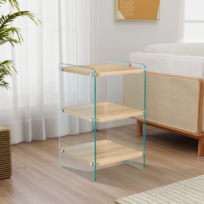 Trois niveaux de tables de chevet. La surface de la planche est en MDF, avec des autocollants, et les deux côtés sont en verre trempé transparent. La conception est simple et généreuse, avec fonction de rangement